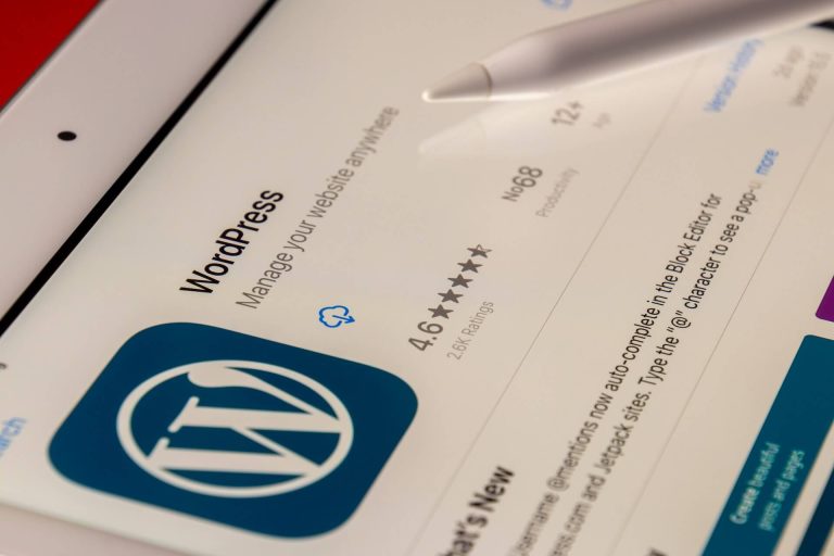 A mobile application displaying the WordPress logo on an iPad screen.